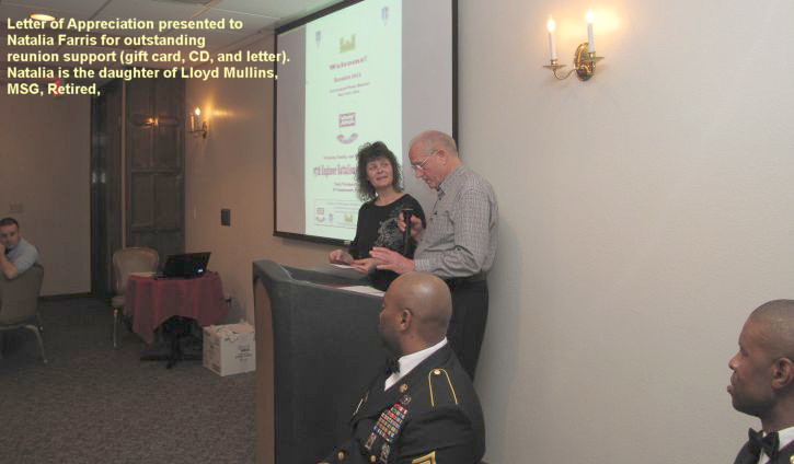 Natalia Farrios receiving a letter of appreciation from the 97th Engineer reunion coordinator